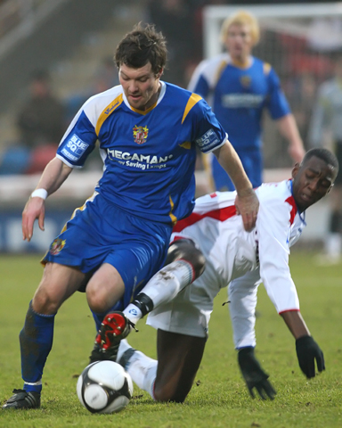 Yannick Bolasie slides in to tackle Scott Laird